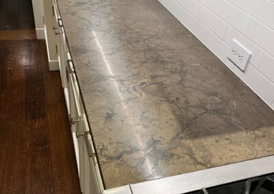 A kitchen with a granite counter top and a stove.